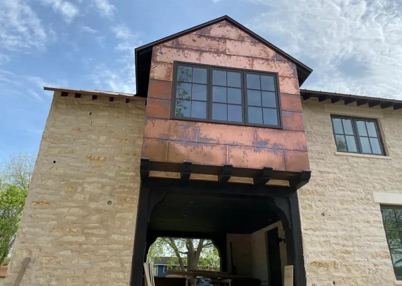 Copper metal panel facade on a stone building for Skylight Installation in San Leandro